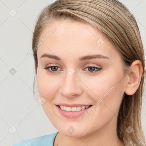 Joyful white young-adult female with long  brown hair and blue eyes