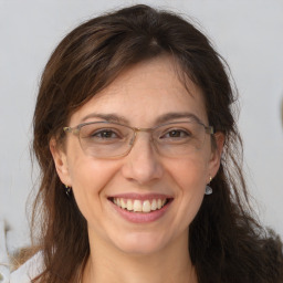 Joyful white adult female with long  brown hair and brown eyes