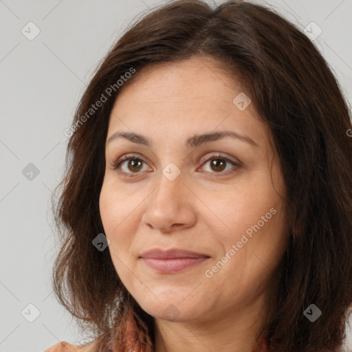 Joyful white adult female with long  brown hair and brown eyes