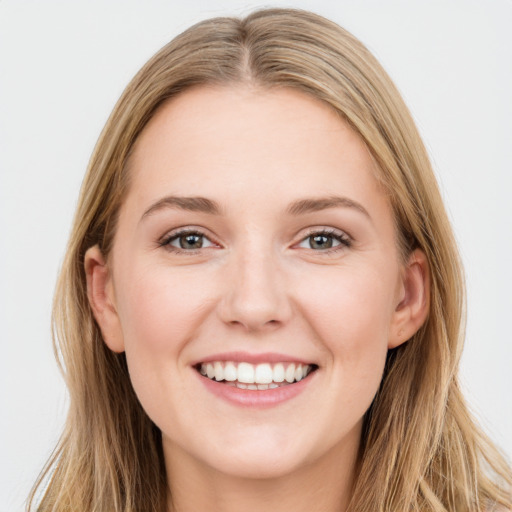 Joyful white young-adult female with long  brown hair and grey eyes