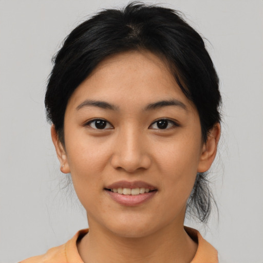 Joyful asian young-adult female with short  brown hair and brown eyes