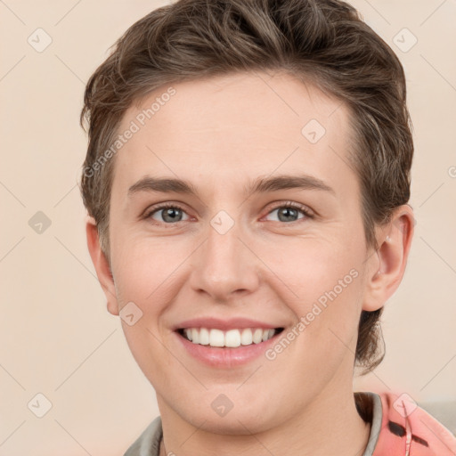 Joyful white young-adult female with short  brown hair and grey eyes