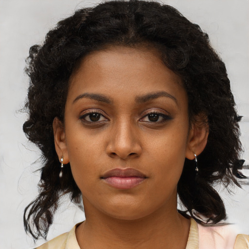 Neutral black young-adult female with medium  brown hair and brown eyes