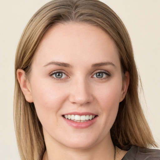 Joyful white young-adult female with long  brown hair and grey eyes