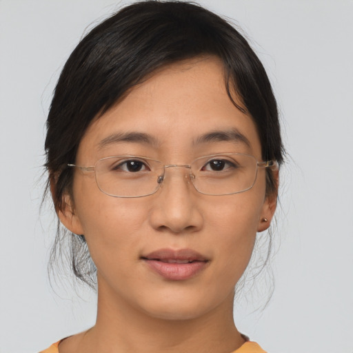 Joyful asian adult female with medium  brown hair and brown eyes