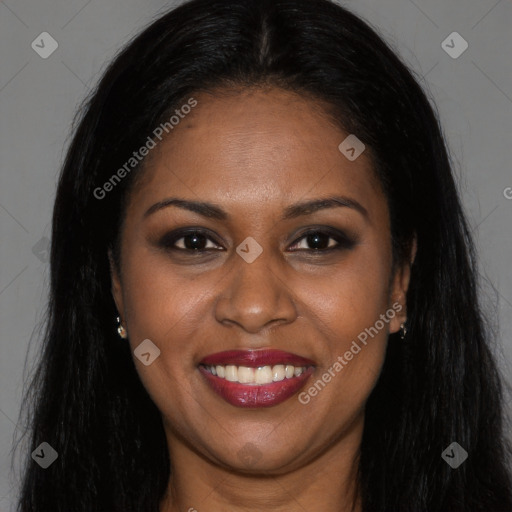 Joyful black young-adult female with long  brown hair and brown eyes