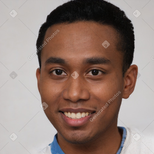 Joyful black young-adult male with short  black hair and brown eyes