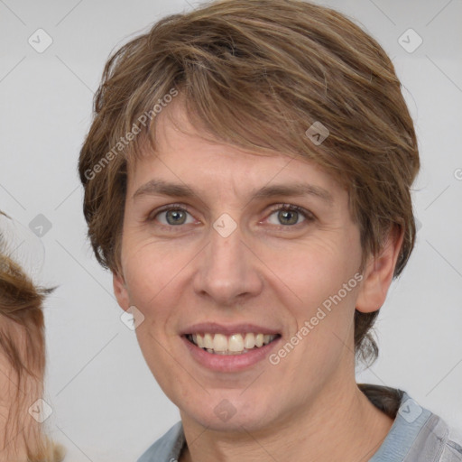 Joyful white adult female with medium  brown hair and grey eyes