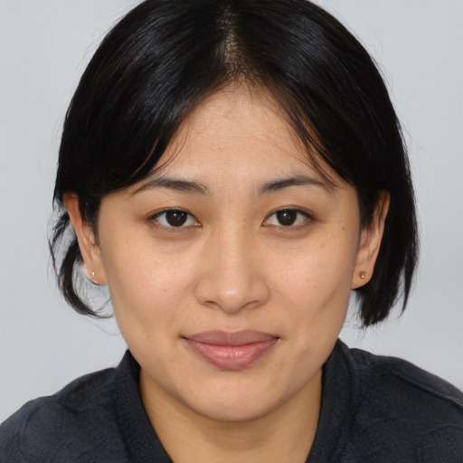 Joyful asian young-adult female with medium  brown hair and brown eyes
