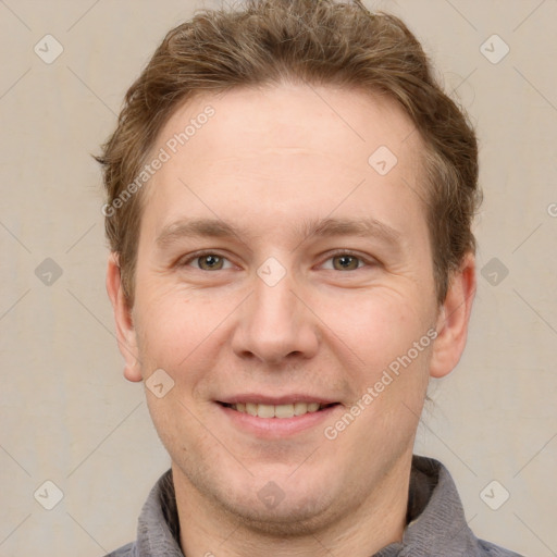 Joyful white adult male with short  brown hair and grey eyes