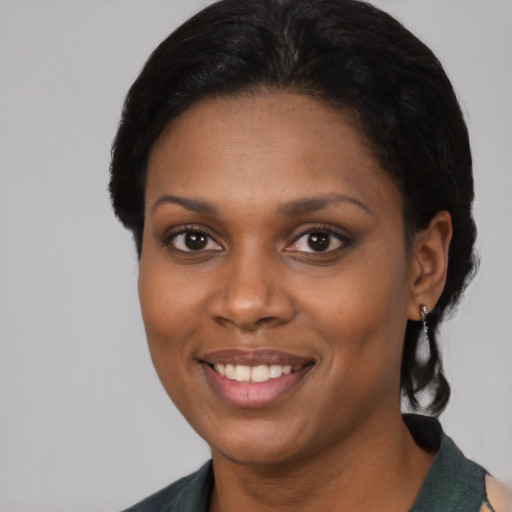 Joyful black young-adult female with medium  black hair and brown eyes