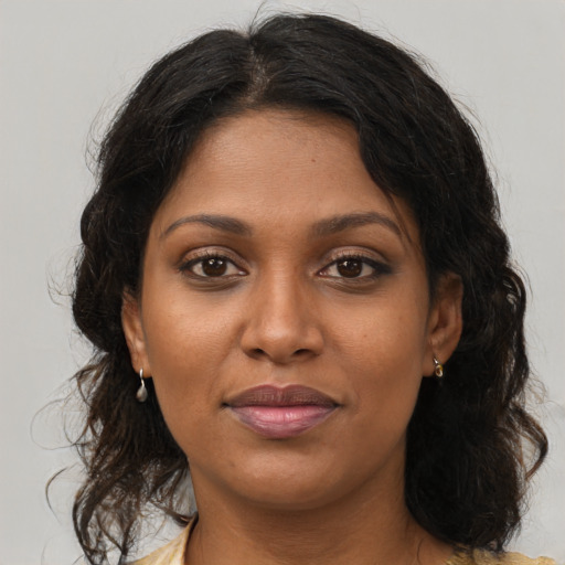 Joyful black young-adult female with medium  brown hair and brown eyes