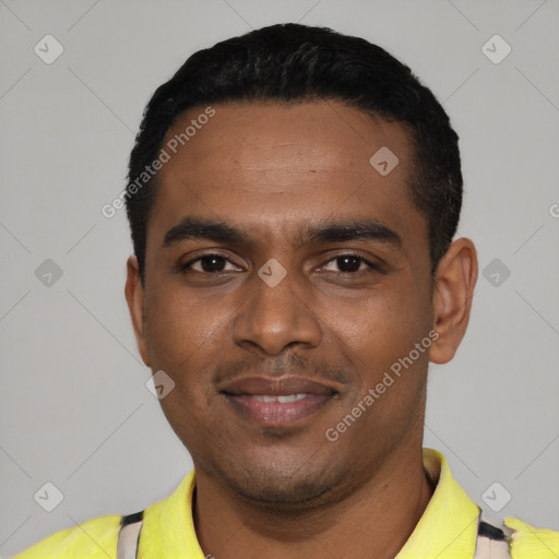 Joyful black young-adult male with short  black hair and brown eyes
