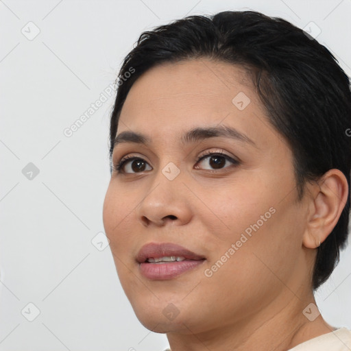 Joyful latino young-adult female with short  brown hair and brown eyes