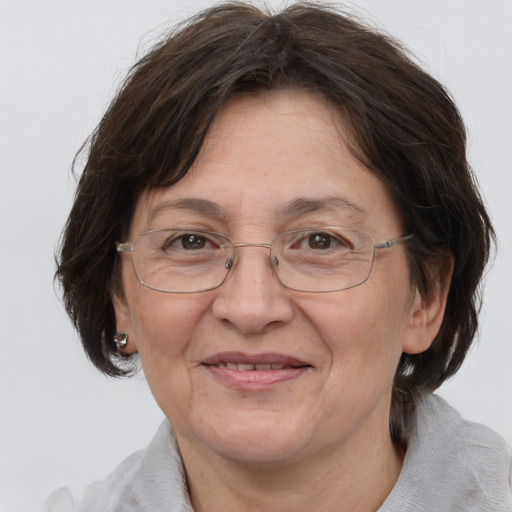 Joyful white middle-aged female with medium  brown hair and grey eyes