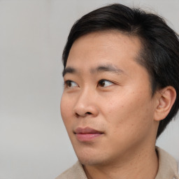 Joyful asian young-adult male with short  brown hair and brown eyes