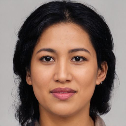 Joyful latino young-adult female with medium  black hair and brown eyes