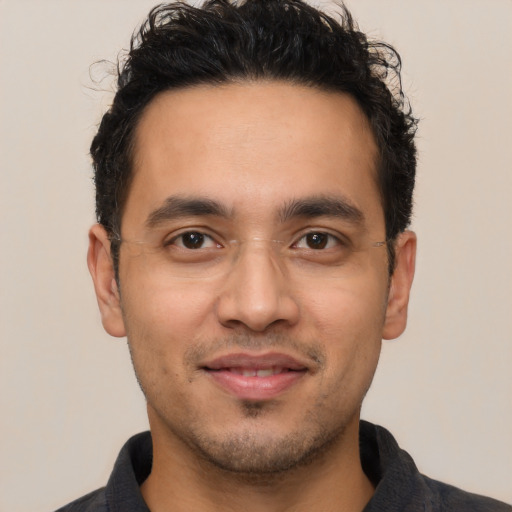 Joyful latino young-adult male with short  black hair and brown eyes