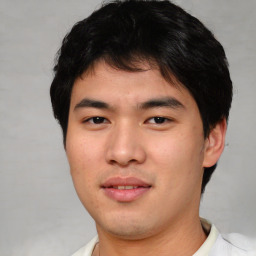 Joyful asian young-adult male with short  black hair and brown eyes