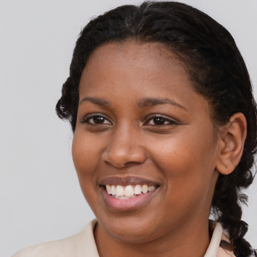 Joyful black young-adult female with medium  brown hair and brown eyes