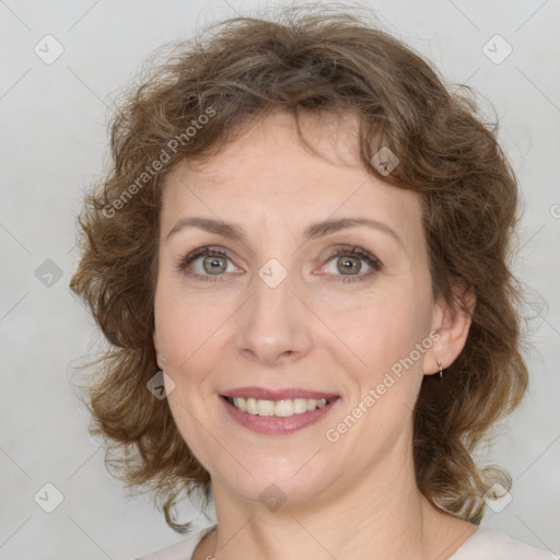 Joyful white young-adult female with medium  brown hair and green eyes