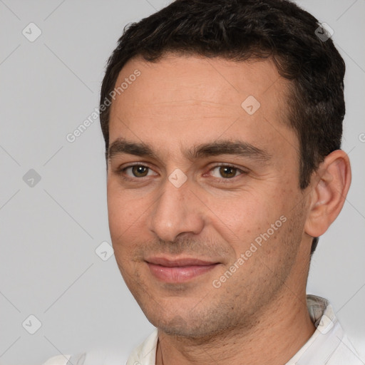 Joyful white young-adult male with short  brown hair and brown eyes