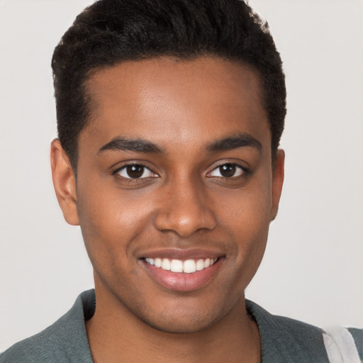 Joyful black young-adult male with short  black hair and brown eyes