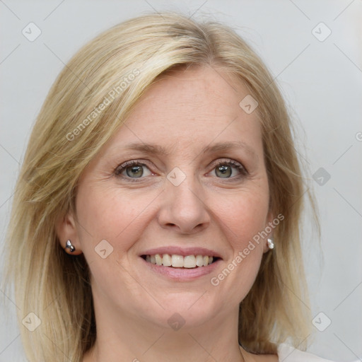 Joyful white adult female with medium  brown hair and blue eyes