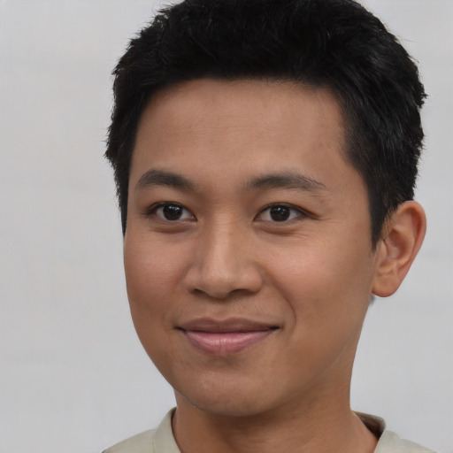 Joyful asian young-adult male with short  black hair and brown eyes