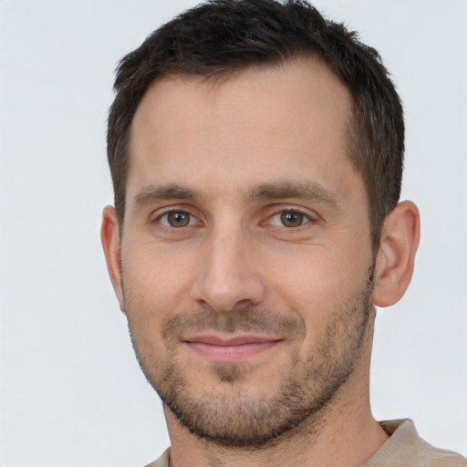 Joyful white young-adult male with short  brown hair and brown eyes