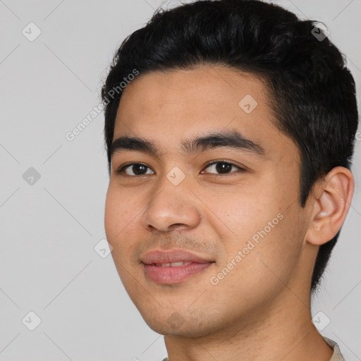 Joyful asian young-adult male with short  black hair and brown eyes