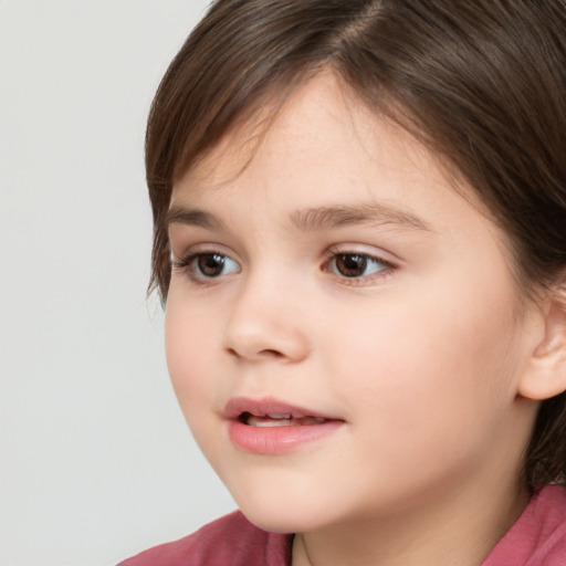 Joyful white child female with long  brown hair and brown eyes