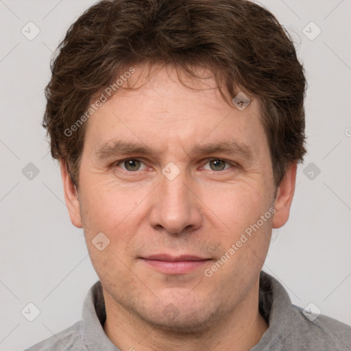 Joyful white adult male with short  brown hair and grey eyes