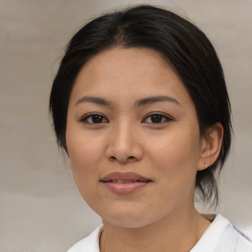 Joyful asian young-adult female with medium  brown hair and brown eyes