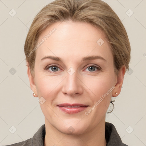 Joyful white adult female with medium  brown hair and grey eyes