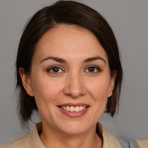 Joyful white adult female with medium  brown hair and brown eyes