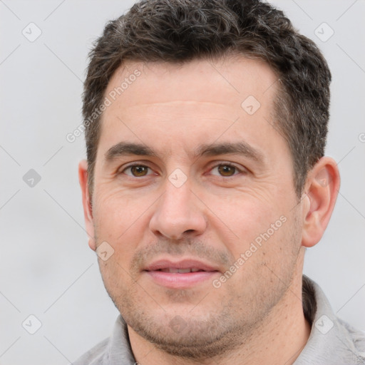 Joyful white adult male with short  brown hair and brown eyes