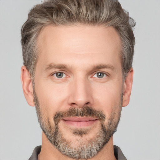 Joyful white adult male with short  brown hair and brown eyes