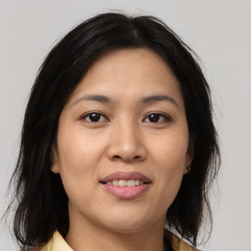 Joyful latino young-adult female with medium  brown hair and brown eyes