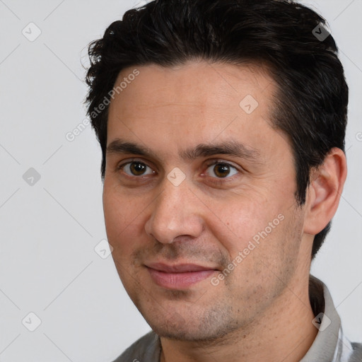 Joyful white adult male with short  brown hair and brown eyes