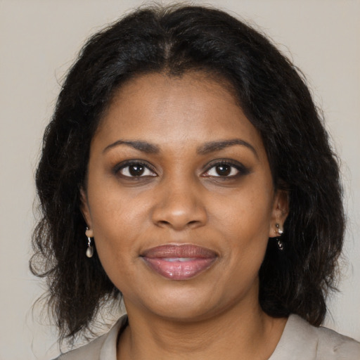 Joyful black young-adult female with medium  brown hair and brown eyes
