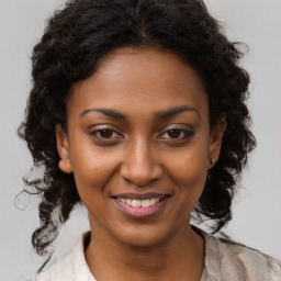 Joyful black young-adult female with medium  brown hair and brown eyes