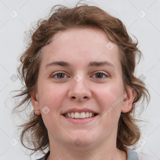 Joyful white young-adult female with medium  brown hair and blue eyes