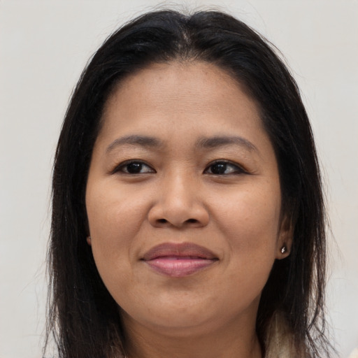 Joyful asian young-adult female with long  brown hair and brown eyes