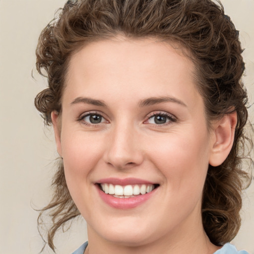 Joyful white young-adult female with medium  brown hair and green eyes