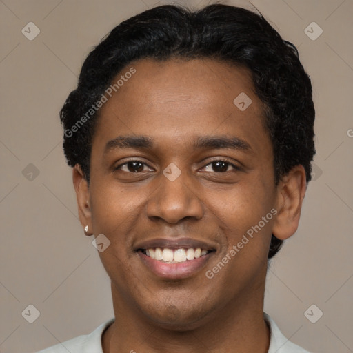 Joyful black young-adult male with short  black hair and brown eyes