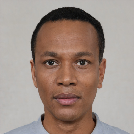 Neutral black adult male with short  black hair and brown eyes
