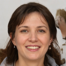 Joyful white adult female with medium  brown hair and grey eyes