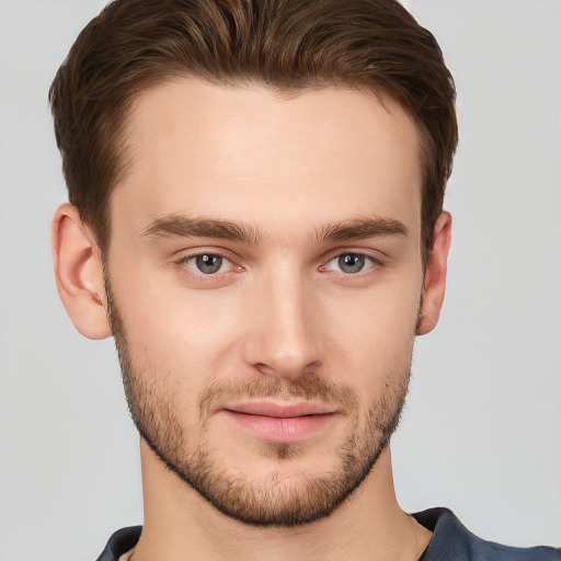 Joyful white young-adult male with short  brown hair and grey eyes