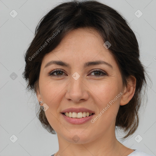 Joyful asian adult female with medium  brown hair and brown eyes